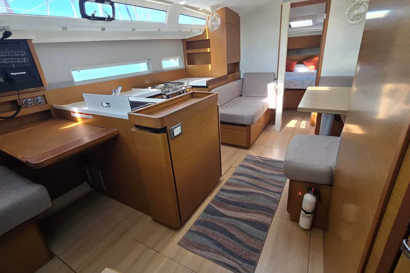 Slide: The Image of Interior of 2020 Jeanneau Sun Odyssey 410 yacht, featuring modern wood finish and cozy seating. - 29