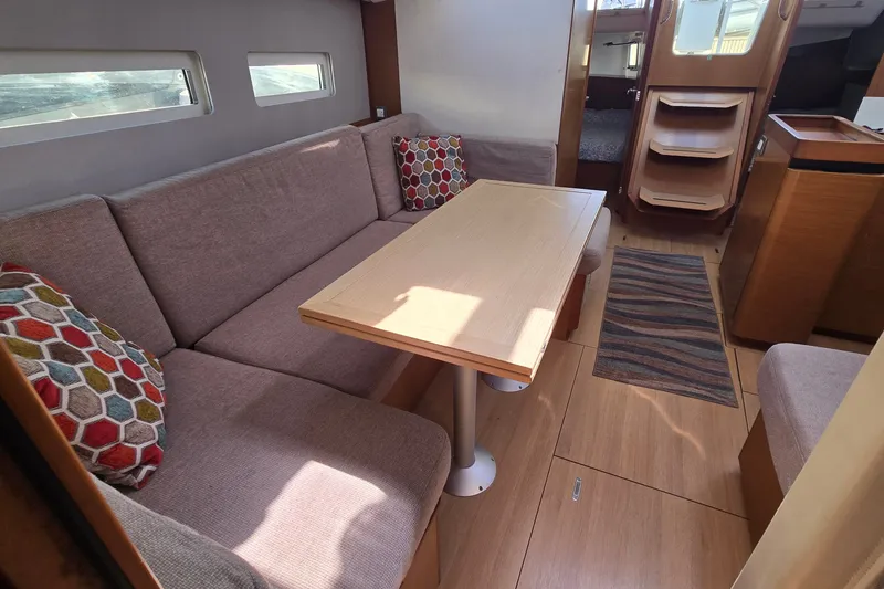 Slide: The Image of Interior of 2020 Jeanneau Sun Odyssey 410 yacht with cozy seating and wooden table. - 40