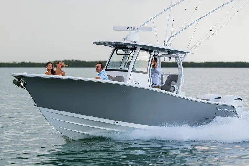 Slide: The Image of Manufacturer Provided Image: 2025 Sportsman Open 282 Center Console boat cruising on water with passengers. - 1