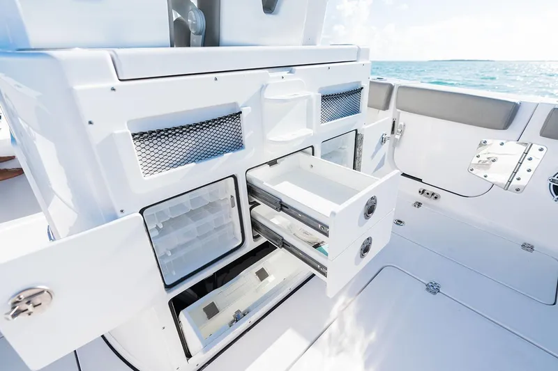 Slide: The Image of Manufacturer Provided Image: 2025 Sportsman Open 282 Center Console boat interior with storage compartments open. - 14