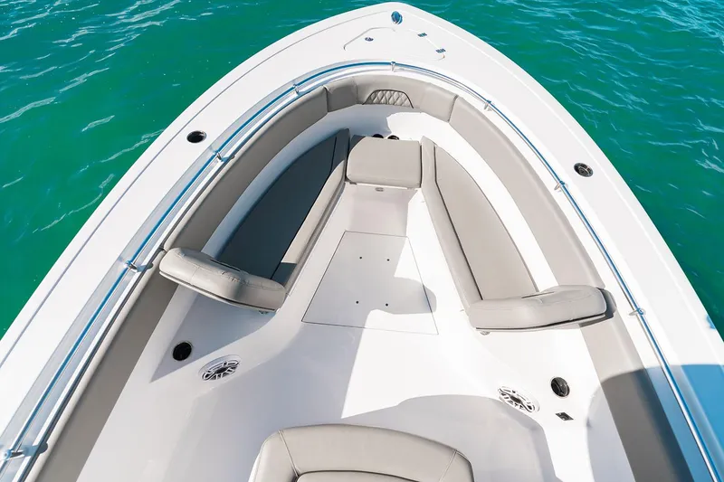 Slide: The Image of Manufacturer Provided Image: 2025 Sportsman Open 282 Center Console boat interior with cushioned seating on turquoise water. - 5