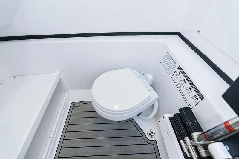 Slide: The Image of Manufacturer Provided Image: 2025 Sportsman Open 282 Center Console boat interior with marine toilet. - 18