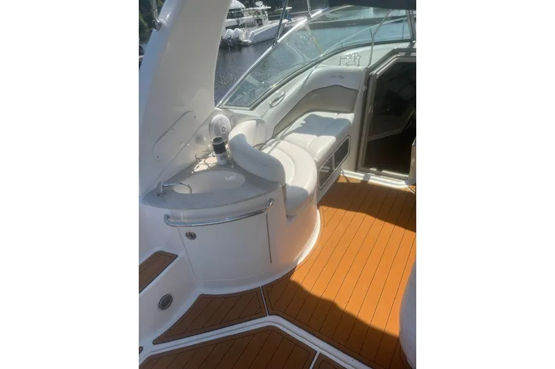 Slide: The Image of Interior view of 2008 Sea Ray 220 Sundancer boat with seating and wood flooring. - 16