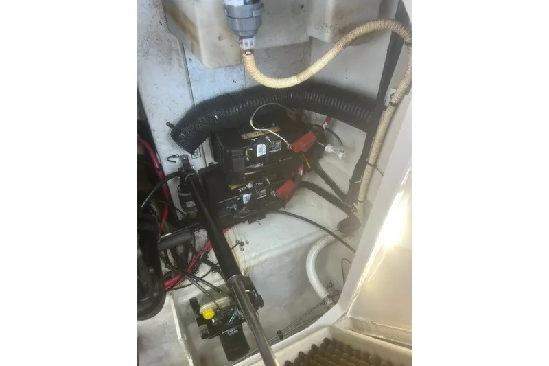 Slide: The Image of Engine compartment of a 2008 Sea Ray 220 Sundancer, showing battery and wiring setup. - 30