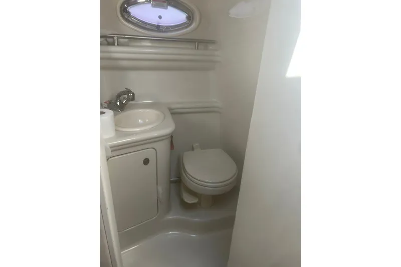 Slide: The Image of Compact bathroom in 2008 Sea Ray 220 Sundancer boat with sink and toilet. - 24