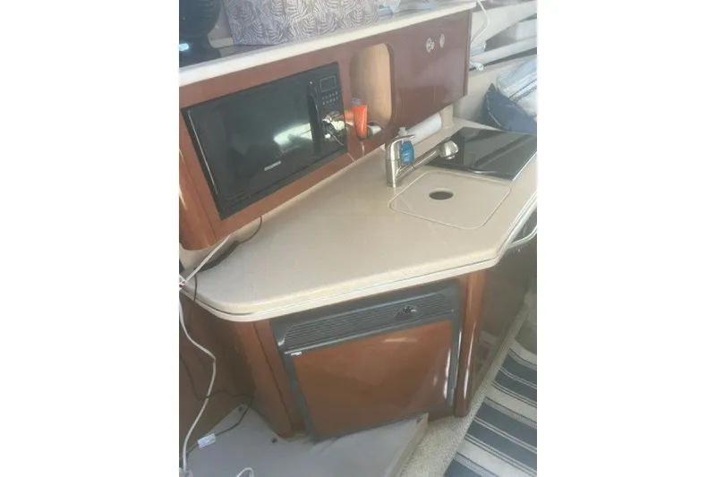 Slide: The Image of Interior kitchenette of 2008 Sea Ray 220 Sundancer with microwave and sink. - 19