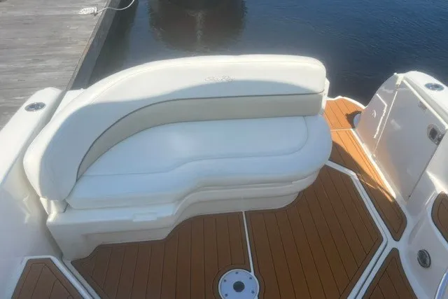 Slide: The Image of White seating on 2008 Sea Ray 220 Sundancer boat with teak flooring. - 17