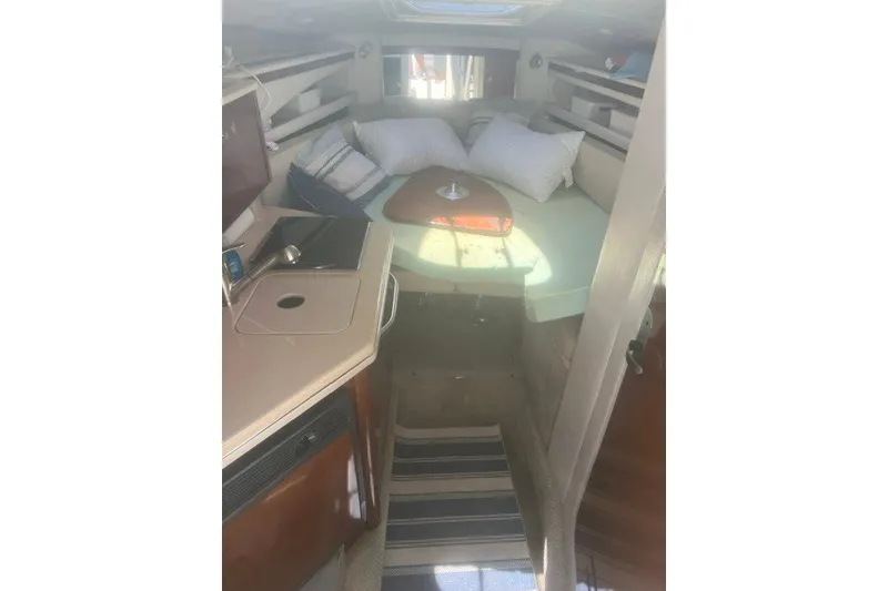 Slide: The Image of Interior of 2008 Sea Ray 220 Sundancer boat with cozy cabin and kitchenette. - 22