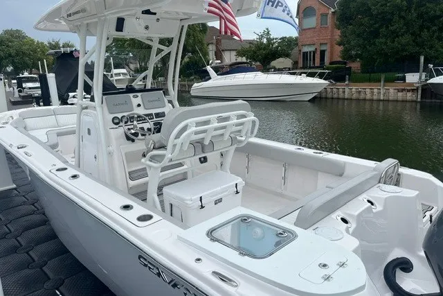 Slide: The Image of 2023 Sea Fox 248 Commander boat docked, featuring modern controls and seating. - 3