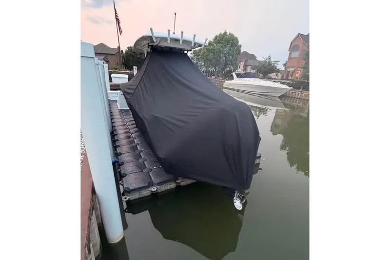 Slide: The Image of Covered 2023 Sea Fox 248 Commander boat docked on calm water. - 8