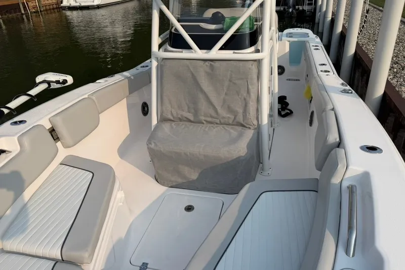 Slide: The Image of 2023 Sea Fox 248 Commander boat interior with cushioned seating and fishing rod holders. - 23