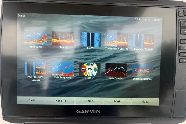 Slide: The Image of Garmin sonar display on 2023 Sea Fox 248 Commander, showcasing various sonar modes and data graphs. - 13
