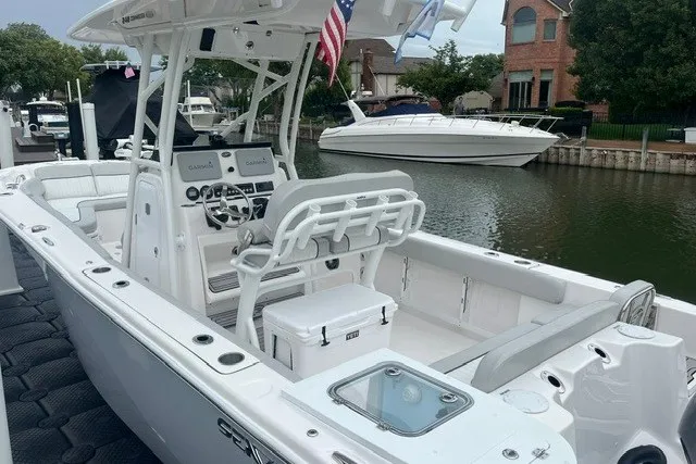 Slide: The Image of 2023 Sea Fox 248 Commander boat docked, featuring spacious seating and modern controls. - 6