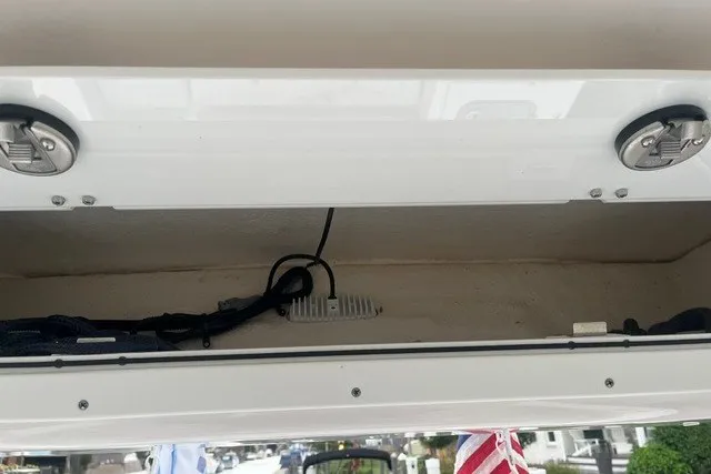 Slide: The Image of Open storage compartment on a 2023 Sea Fox 248 Commander boat, showing wiring and latches. - 32
