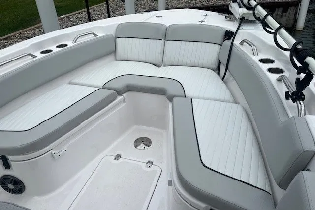 Slide: The Image of 2023 Sea Fox 248 Commander boat interior with cushioned seating and cup holders. - 25