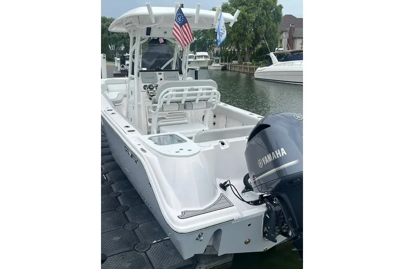 Slide: The Image of 2023 Sea Fox 248 Commander boat with Yamaha engine docked by waterfront. - 4