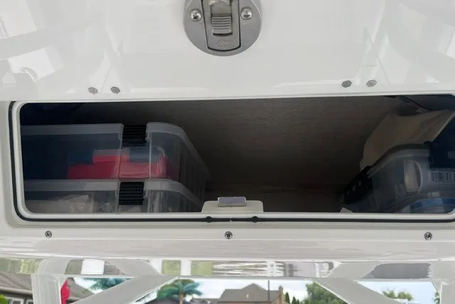 Slide: The Image of Storage compartment on a 2023 Sea Fox 248 Commander boat with organized containers. - 31