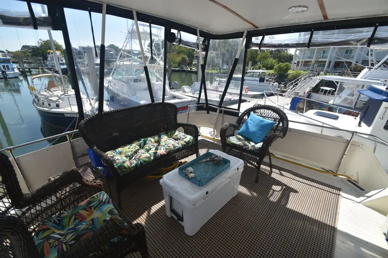 Slide: The Image of The image shows the aft deck of a 1981 Viking 43 Aft Cabin with cozy seating. - 35