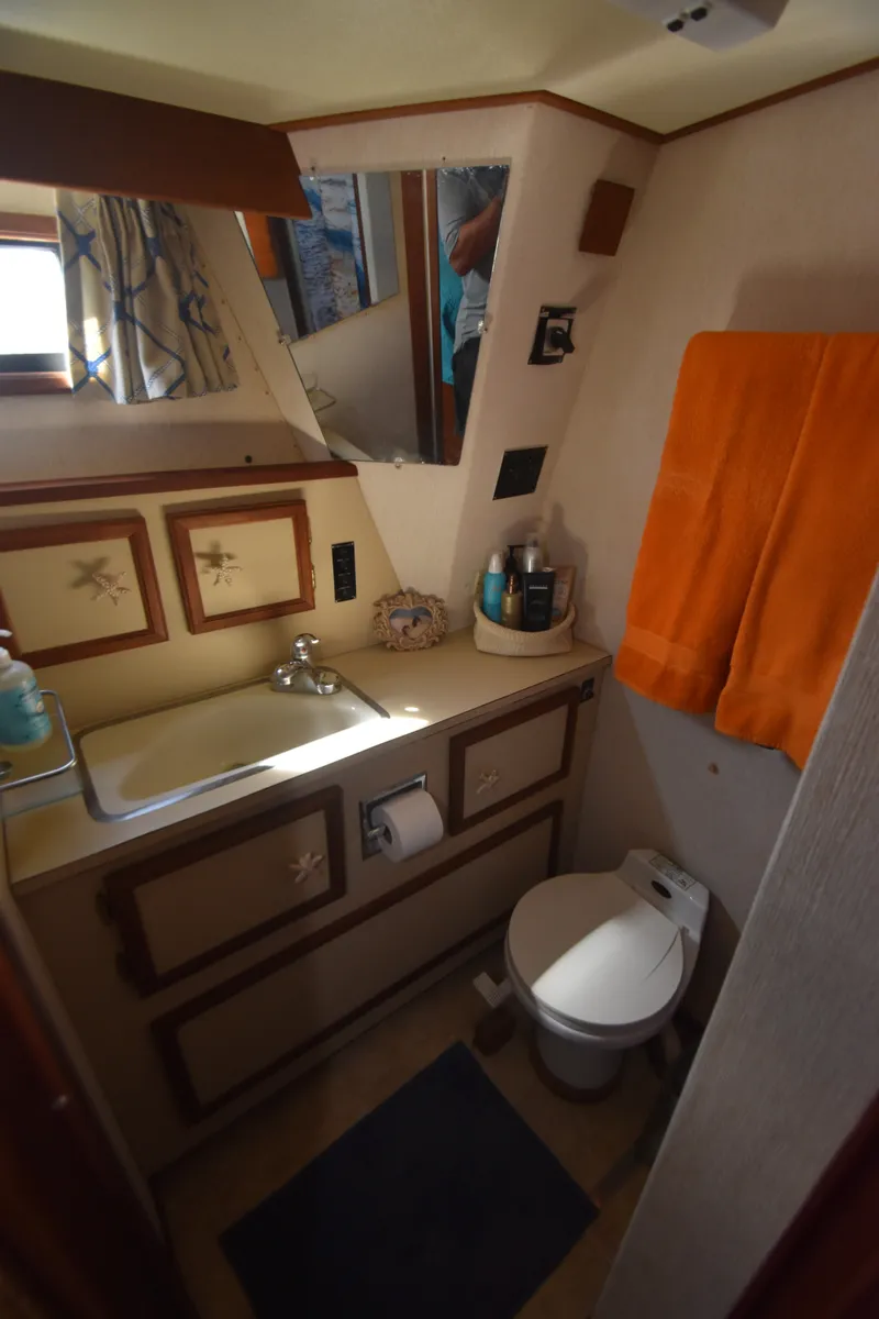 Slide: The Image of The image shows a yacht bathroom with a sink, toilet, and mirror. - 28
