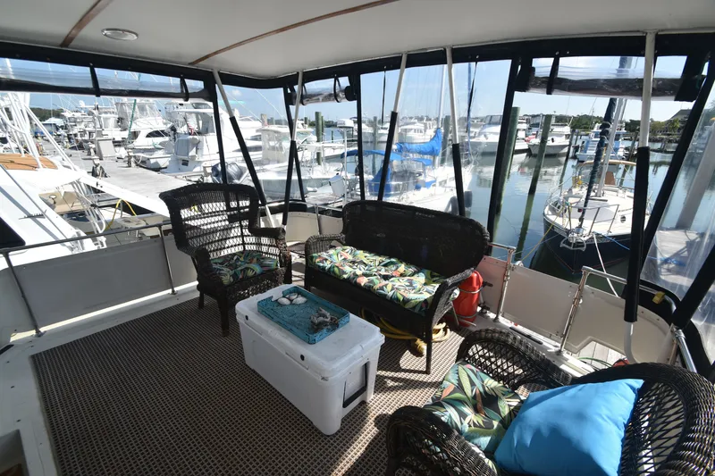 Slide: The Image of The interior of a 1981 Viking 43 Aft Cabin with wicker furniture and marina view. - 36