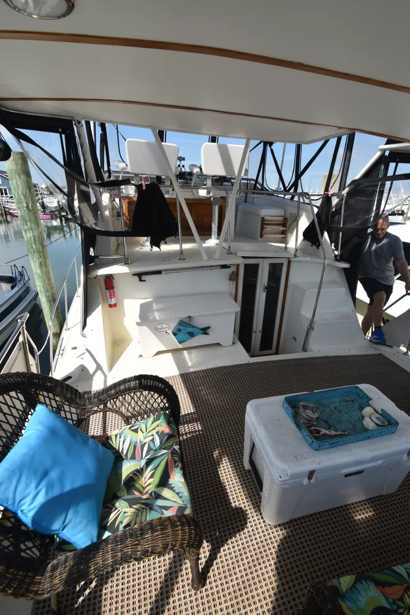 Slide: The Image of 1981 Viking 43 Aft Cabin with a cozy seating area and harbor view. - 48