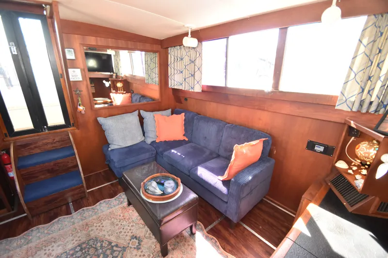 Slide: The Image of Cozy living area with blue couch and wood accents in a 1981 Viking 43 Aft Cabin. - 15