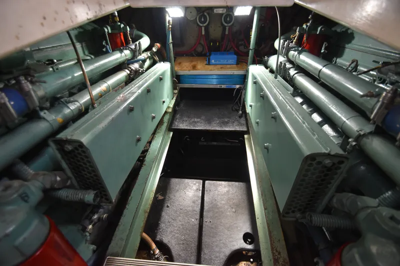 Slide: The Image of The engine room of a 1981 Viking 43 Aft Cabin shows two large engines and piping. - 31