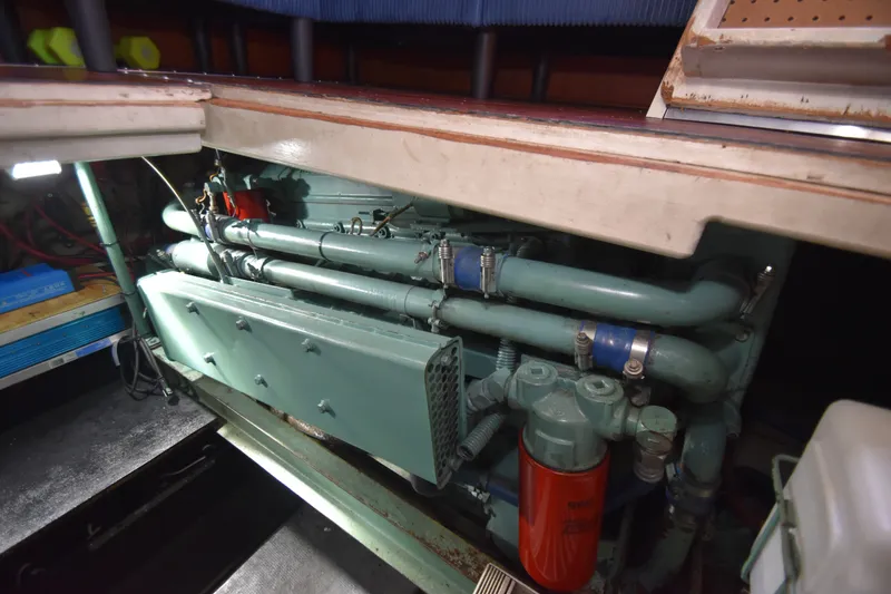 Slide: The Image of The engine room of a 1981 Viking 43 Aft Cabin with visible pipes and components. - 33