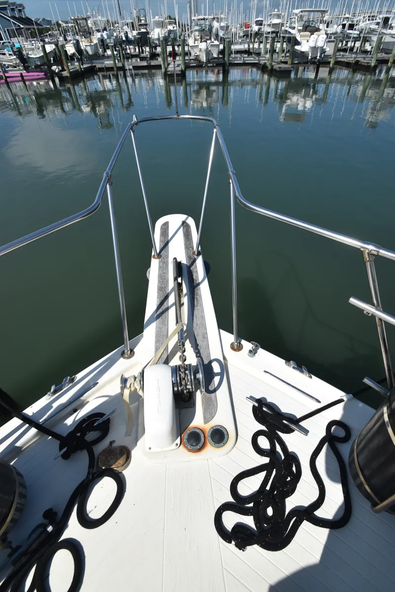 Slide: The Image of Bow view of a yacht with anchor windlass and ropes, docked in a marina. - 46