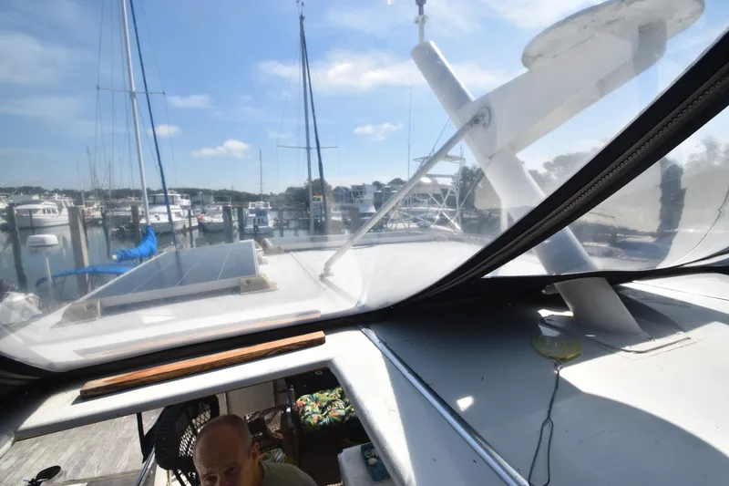 Slide: The Image of View from the cabin of a 1981 Viking 43 Aft Cabin overlooking a marina with several boats. - 42
