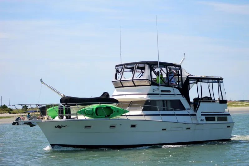 The Image of A 1981 Viking 43 Aft Cabin boat on the water with kayaks on board. - 0