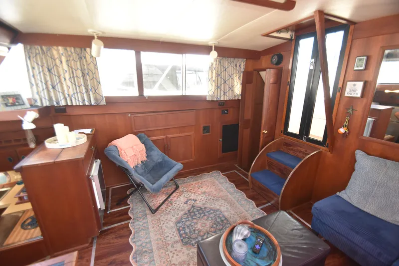 Slide: The Image of The interior of a 1981 Viking 43 Aft Cabin with wood paneling, carpet, and cozy seating. - 20