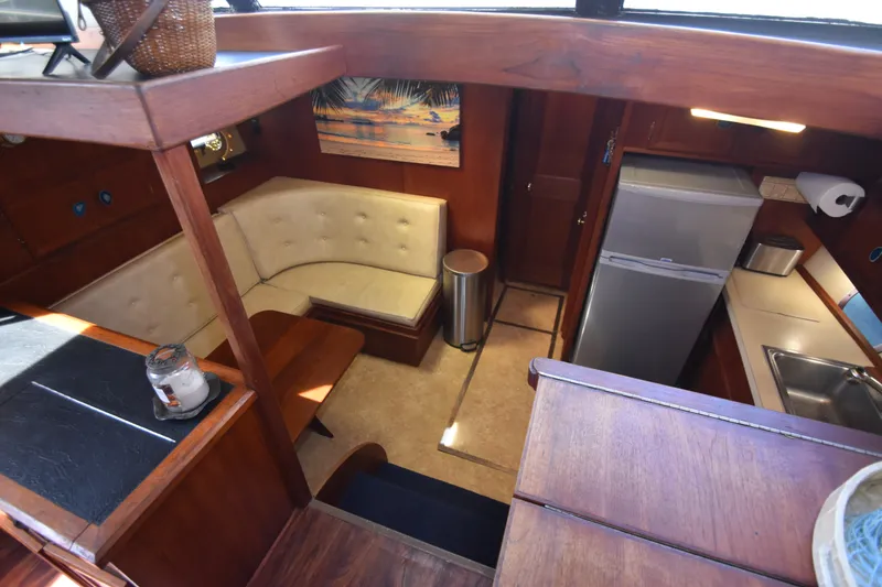 Slide: The Image of Interior of a 1981 Viking 43 Aft Cabin with wood furnishings and a kitchen area. - 14