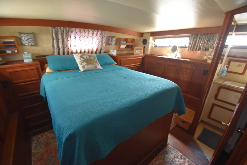 Slide: The Image of The image shows a cozy cabin with a large bed, wooden furniture, and windows. - 23
