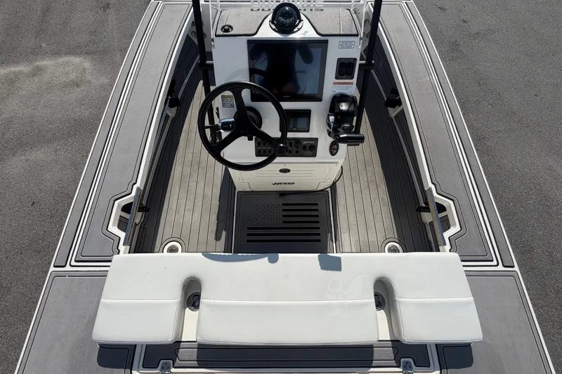 Slide: The Image of 2022 Hewes Redfisher 16 boat cockpit with steering wheel and control panel. - 16