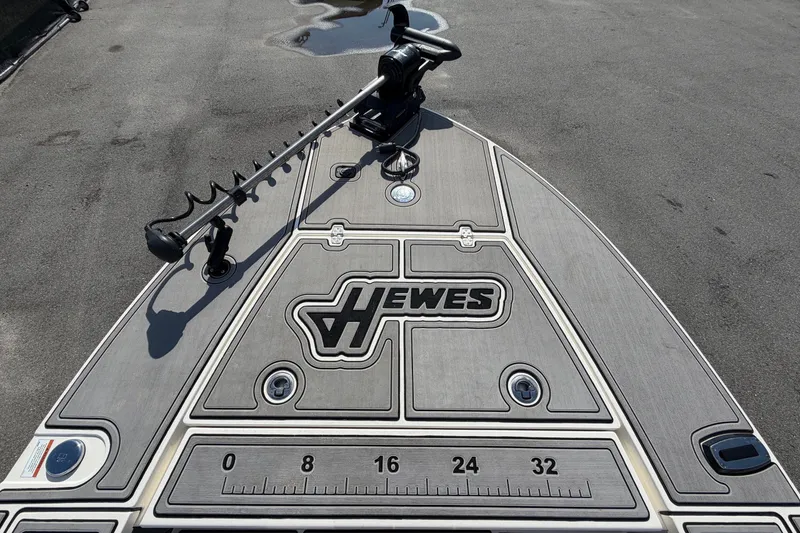 Slide: The Image of The image shows the deck of a Hewes Redfisher 16 boat with a trolling motor. - 29