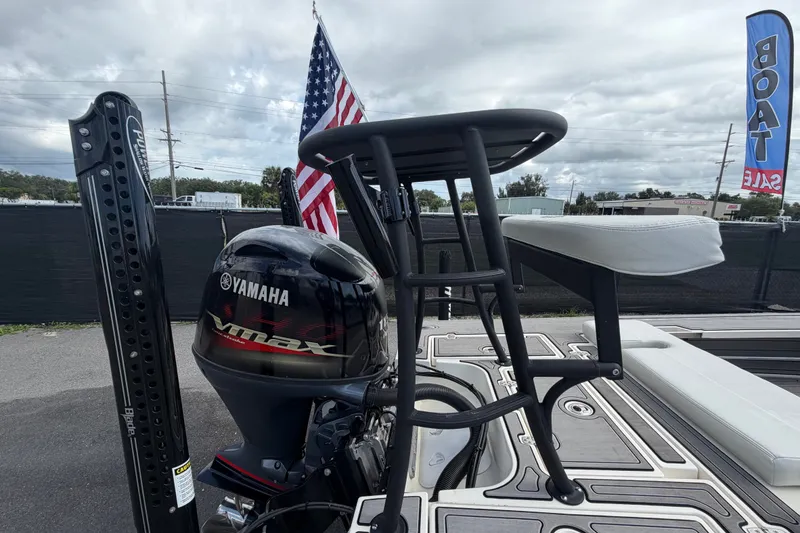 Slide: The Image of 2022 Hewes Redfisher 16 boat with Yamaha VMAX engine, American flag, and sale banner. - 59