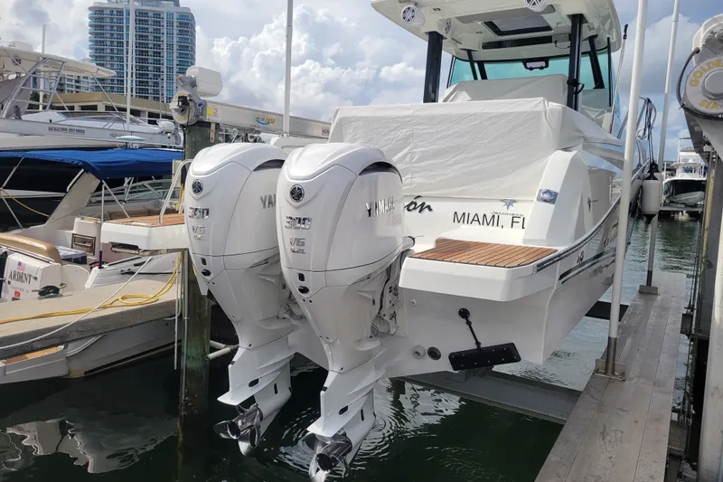 Slide: The Image of 2025 Jeanneau Leader 10.5 WA Series 2 boat with twin Yamaha engines docked in Miami. - 3