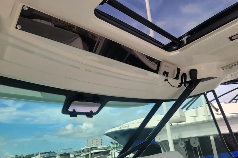 Slide: The Image of Interior view of 2025 Jeanneau Leader 10.5 WA Series 2 boat with open sunroof. - 14