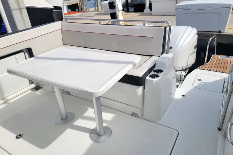 Slide: The Image of 2025 Jeanneau Leader 10.5 WA Series 2 boat deck with seating and table. - 16
