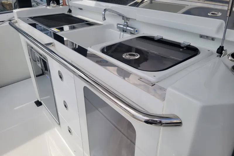 Slide: The Image of 2025 Jeanneau Leader 10.5 WA Series 2 boat kitchen with sink and storage. - 8