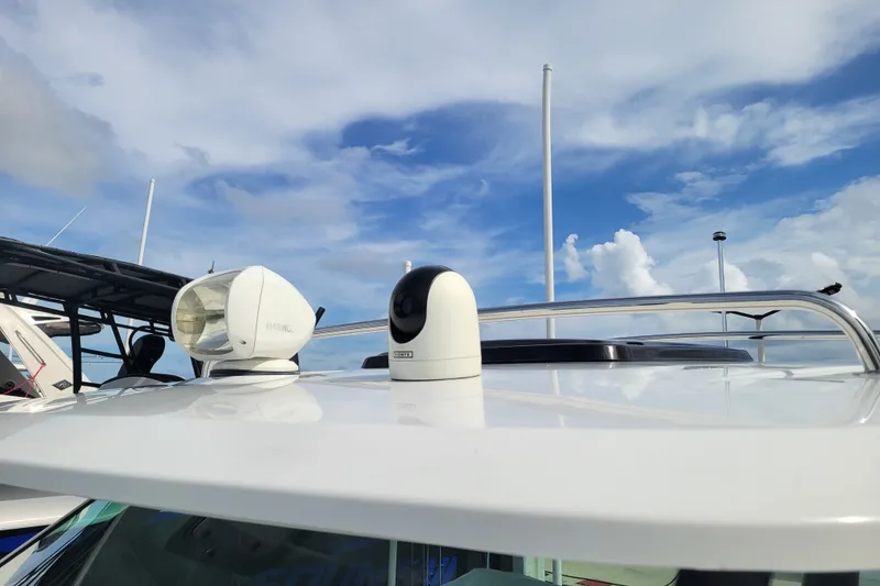Slide: The Image of 2025 Jeanneau Leader 10.5 WA Series 2 boat roof with radar and camera under blue sky. - 15