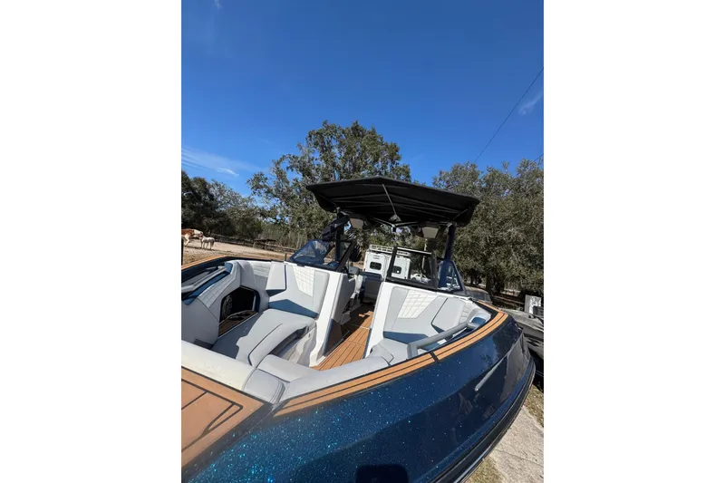 Slide: The Image of 2022 Nautique Super Air Nautique S23 boat with sleek design and spacious seating. - 24