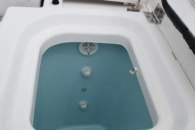 Slide: The Image of Livewell on 2022 Pursuit OS 355 Offshore boat, filled with water. - 60