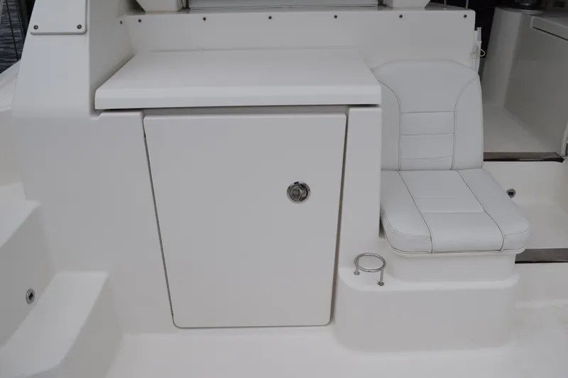 Slide: The Image of 2022 Pursuit OS 355 Offshore boat interior with white seating and storage compartment. - 35
