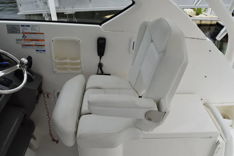 Slide: The Image of 2022 Pursuit OS 355 Offshore helm seat with steering wheel and control panel. - 248