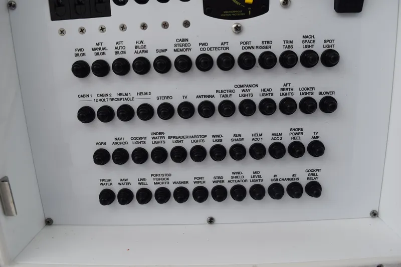 Slide: The Image of Control panel of a 2022 Pursuit OS 355 Offshore boat with labeled switches. - 171
