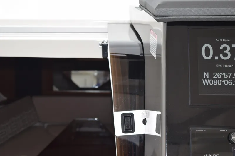 Slide: The Image of 2022 Pursuit OS 355 Offshore boat interior with GPS display and cabin view. - 330