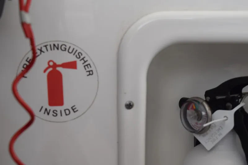 Slide: The Image of Fire extinguisher compartment on 2022 Pursuit OS 355 Offshore boat. - 267