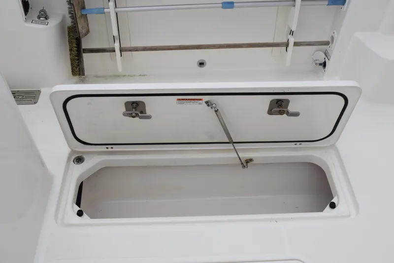Slide: The Image of Open storage compartment on 2022 Pursuit OS 355 Offshore boat deck. - 120